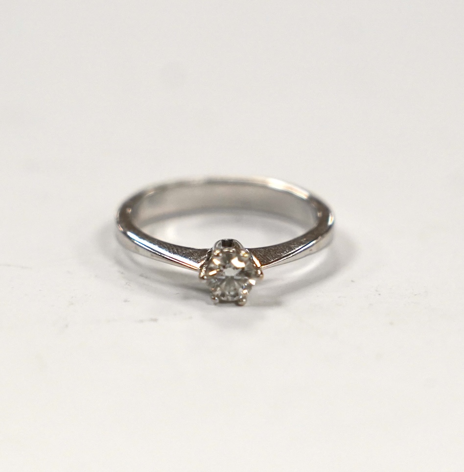 A 14k white metal and solitaire diamond set ring, size H, gross weight 2 grams.